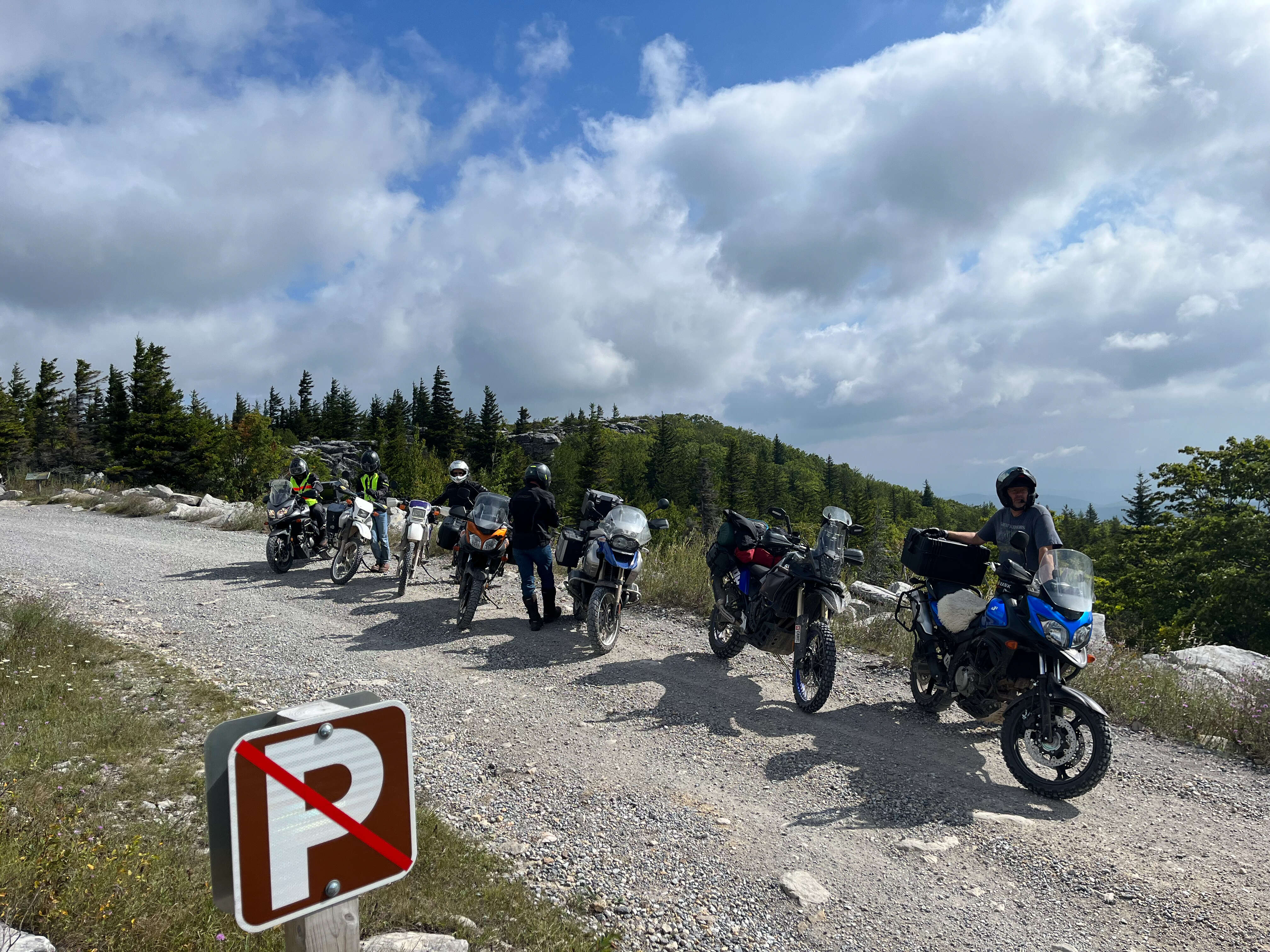 A group of bikes parked in the gravel parking lot at Bear Rocks Preserve.