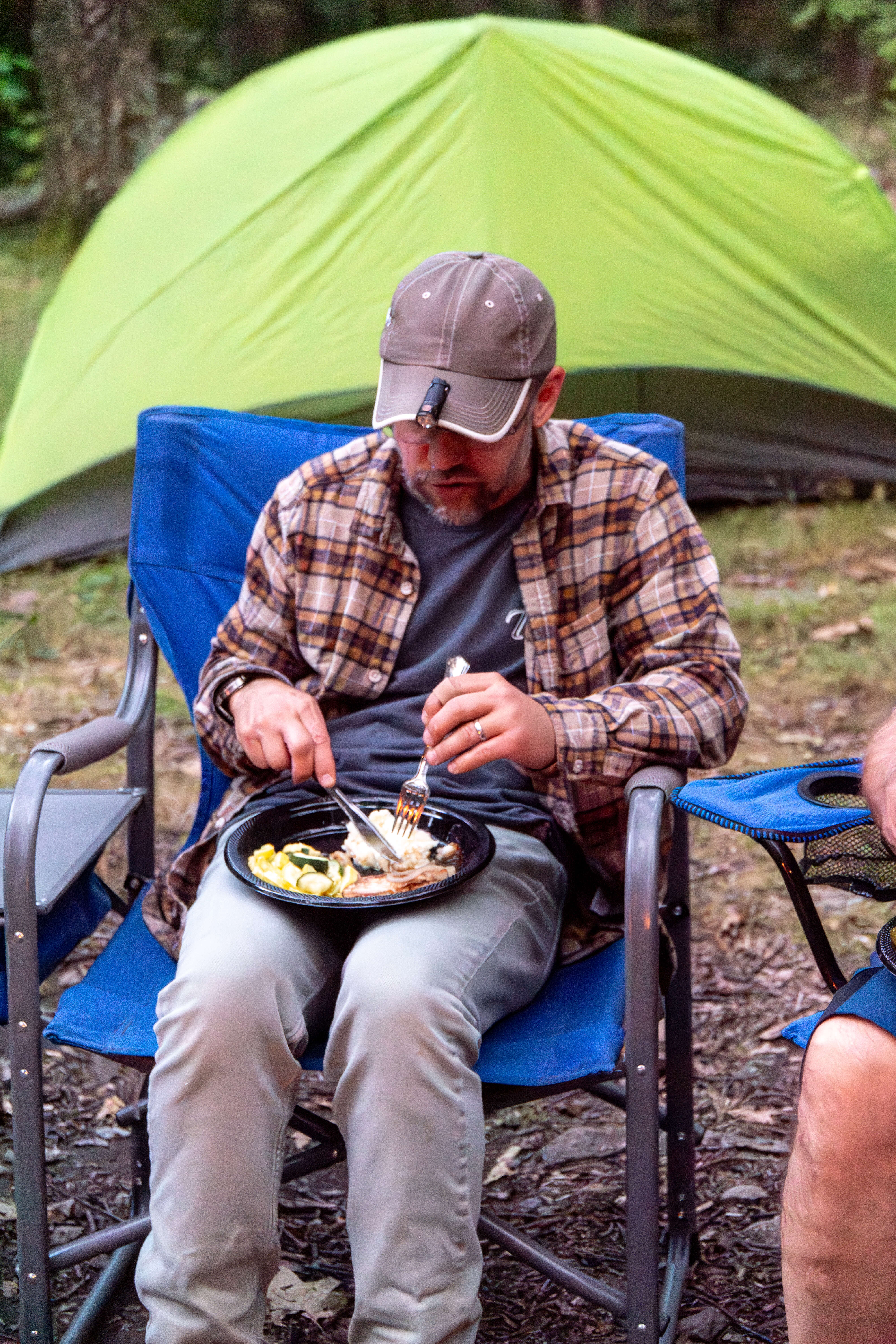 A guy eating steak, squash, and zucchini for dinner.
